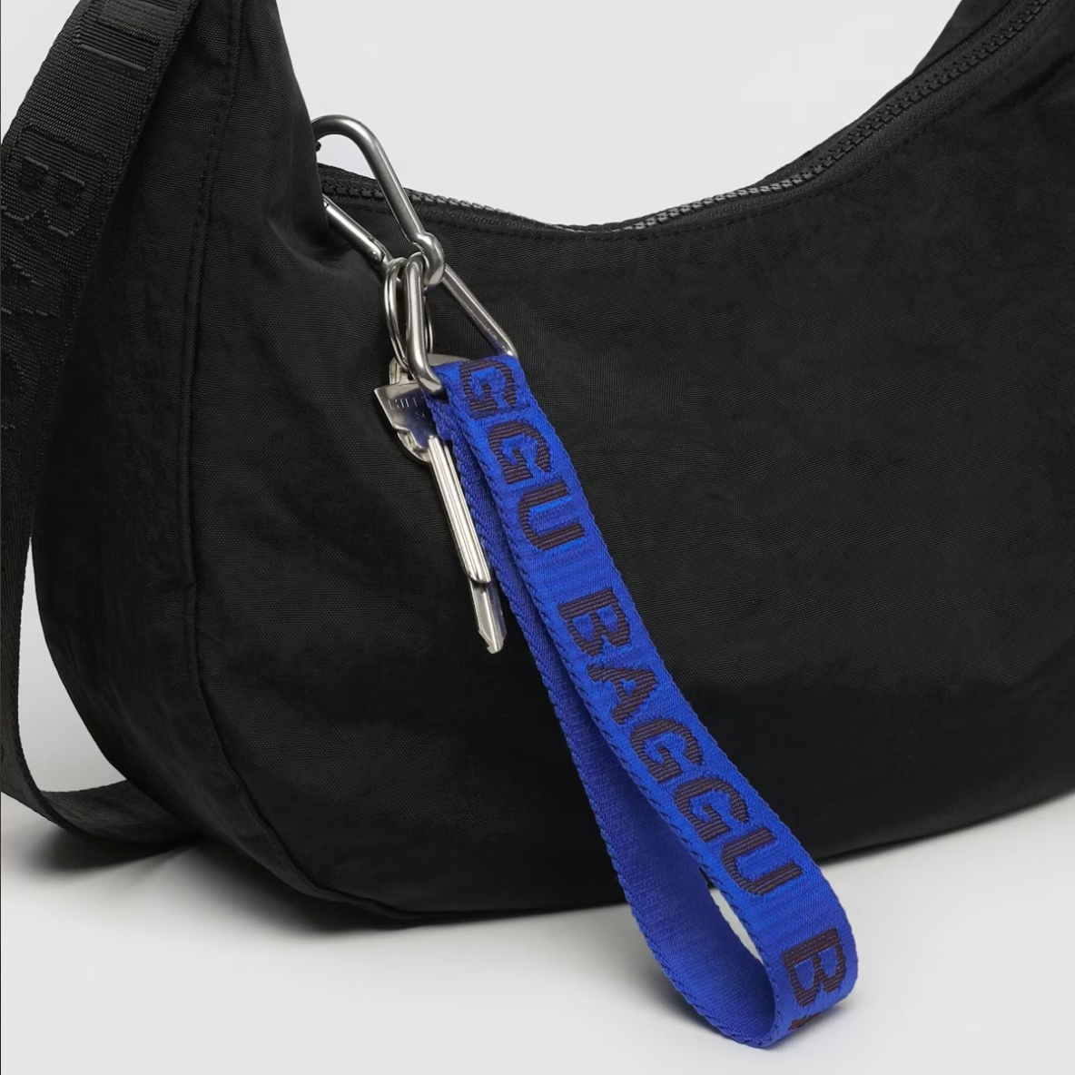 baggu logo keychain in cobalt blue on black bag