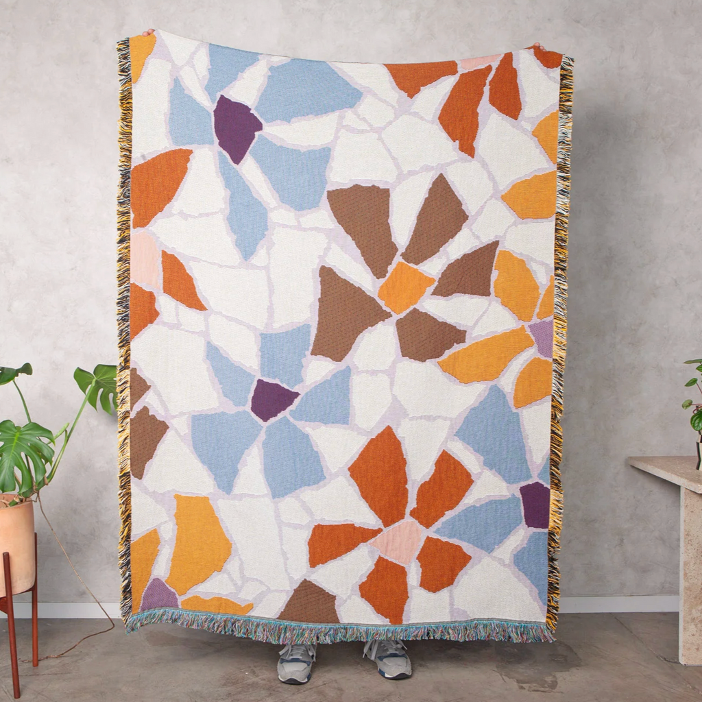 Slowdown Studio Guthrie throw includes white, blue, purple, brown and red shapes in an abstract floral design 